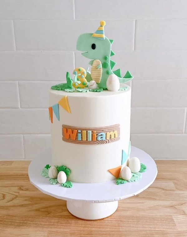 Bánh kem tròn với hình khủng long đội nón dễ thương